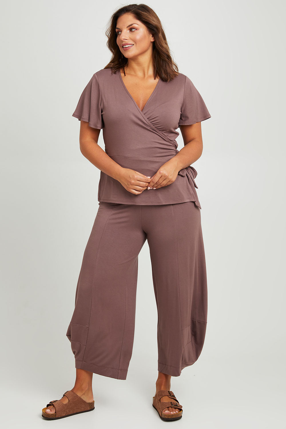 Model Monique wearing size 14 of the Good Vibes Balloon Hem Pants in colour Tobacco, from the front, showing the whole outfit