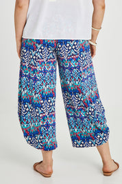 Model Keeara wearing size 16 of the Good Vibes Balloon Hem Pants in colour Aztec (Blue), from the back