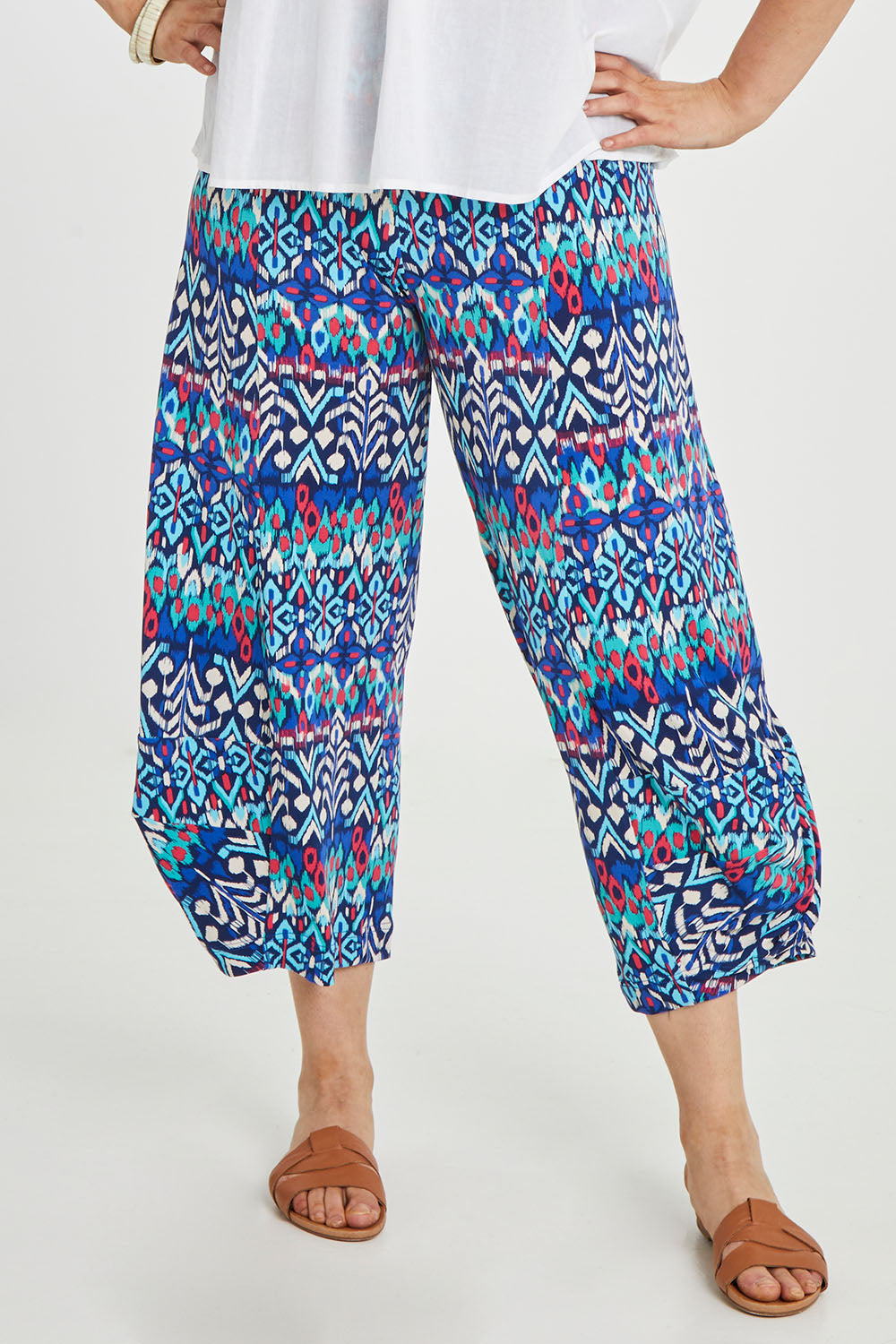 Model Keeara wearing size 16 of the Good Vibes Balloon Hem Pants in colour Aztec (Blue), from the front, cropped image
