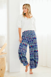 Model Tegan wearing size 10 of the Good Vibes Balloon Hem Pants in colour Aztec (Blue), from the front, showing the whole outfit