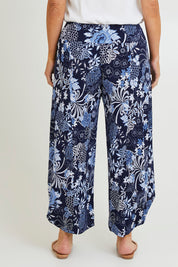 Model Laura wearing size 14 of the Good Vibes Balloon Hem Pants in colour Bluefleur (Blue), from the back