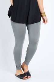 Model Laura wearing size 12 of the Softly Swinging Bamboo Leggings in colour Fern (Green), from the front, cropped image