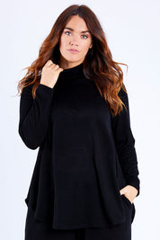Model Laura wearing size 14 of the Falling For You Skivvy Tunic in colour Black (Black), from the front, cropped image
