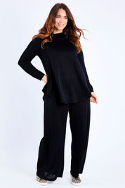Model Laura wearing size 14 of the Falling For You Skivvy Tunic in colour Black (Black), from the front, showing the whole outfit