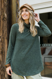 Model Tegan wearing size 10 of the Falling For You Skivvy Tunic in colour Khaki (Green), from the front, showing the whole outfit