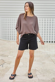 Model Tegand wearing size 10 of the Youre Always There For Me Plain Boyfriend Shorts – Black in colour Black, from the front