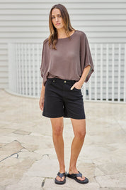 Model Tegand wearing size 10 of the Youre Always There For Me Plain Boyfriend Shorts – Black in colour Black, from the front