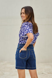 Model Tegand wearing size 10 of the Youre Always There For Me Plain Boyfriend Shorts – Darkdenim in colour Darkdenim, from an angle