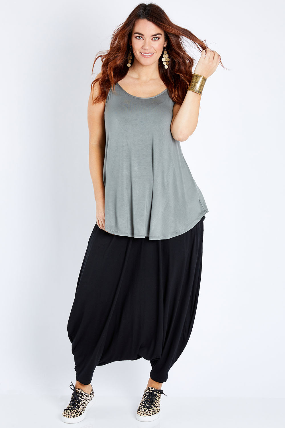 Model Laura wearing size 12 of the Softly Swinging Bamboo Scoop Singlet in colour Fern (Green), from the front, showing the whole outfit