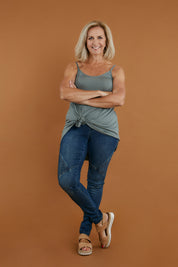 Model Sandy wearing size 10 of the Softly Swinging Bamboo Scoop Singlet in colour Fern (Green), from the front, showing the whole outfit