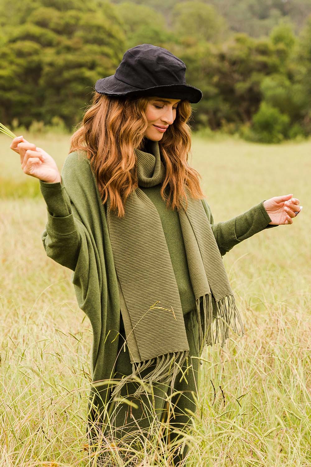 Model Ilona wearing size OneSize of the All Wrapped Up Cotton Scarf in colour Khaki (Green), from the front, showing the whole outfit