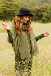 Model Ilona wearing size OneSize of the All Wrapped Up Cotton Scarf in colour Khaki (Green), from the front, showing the whole outfit
