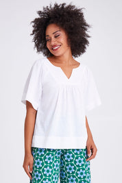 Model Olivia wearing size 10 of the Freya Top in colour White (White), from the front, cropped image