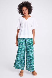Model Olivia wearing size 10 of the Freya Top in colour White (White), from the front, showing the whole outfit