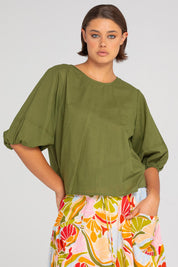 A model wearing the Ava Cotton Top in colour Khaki (Green), from the front, cropped image