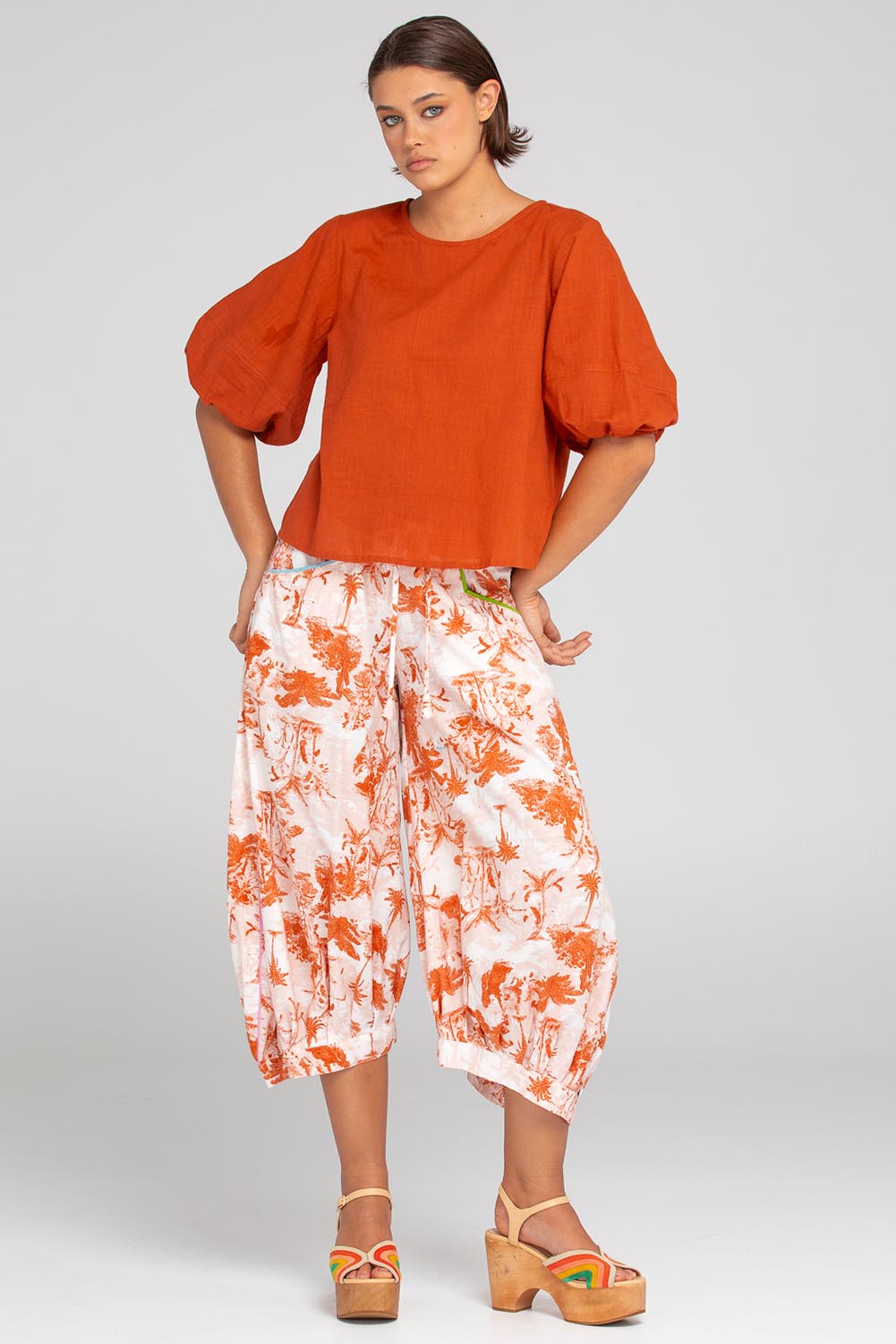 A model wearing the Ava Cotton Top in colour Mecca, from the front, showing the whole outfit