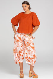 A model wearing the Ava Cotton Top in colour Mecca, from the front, showing the whole outfit