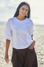Model Eshan wearing size 10 of the Ava Top - White in colour White, in a cropped view