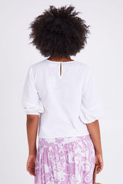 Model Olivia wearing size 10 of the Ava Top in colour White (White), from the back