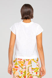 A model wearing the Leaf Cotton Top in colour White (White), from the back