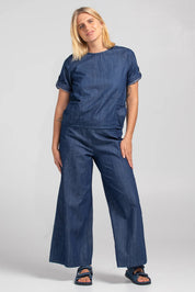 A model wearing the Guru Denim Top in colour Darkdenim (Blue), from the front, showing the whole outfit