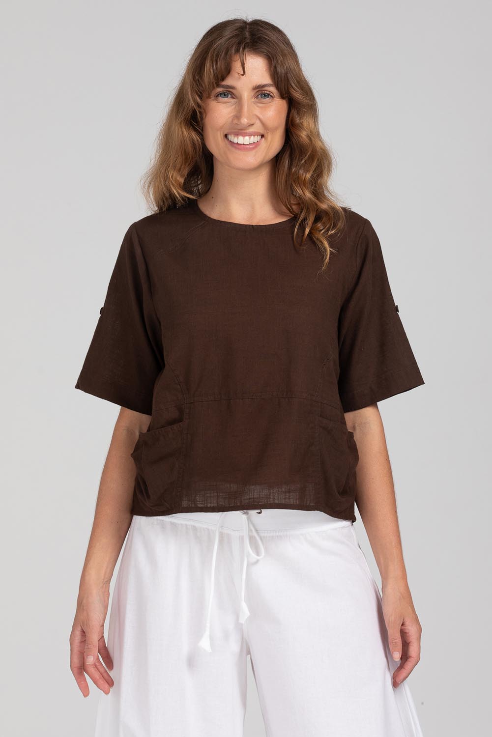 A model wearing the Guru Cotton Top in colour Coffee (Black), from the front, cropped image
