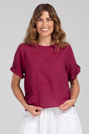A model wearing the Guru Cotton Top in colour Magenta (Purple), from the front, cropped image