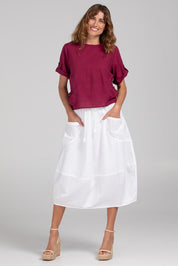 A model wearing the Guru Cotton Top in colour Magenta (Purple), from the front, showing the whole outfit