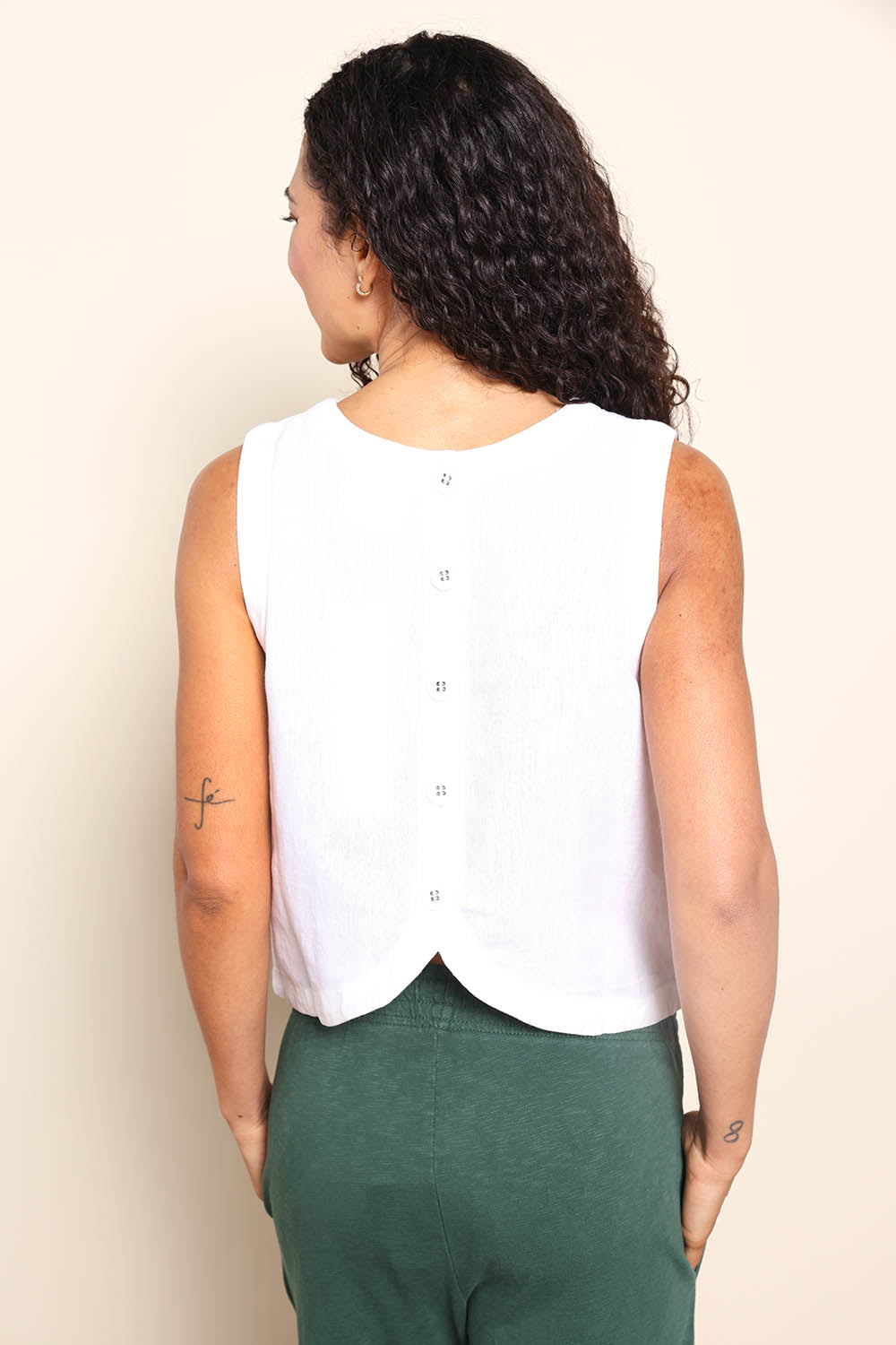 Model Pamelar wearing size 10 of the Rose Linen Top - White in colour White, from the back