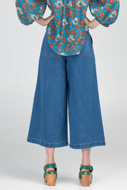 A model wearing the Aspen Pant in colour Brando (Blue), from the back