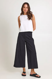 Model Madeline wearing size 10 of the Jedda Linen Cotton Pant in colour Black (Black), from the front, showing the whole outfit
