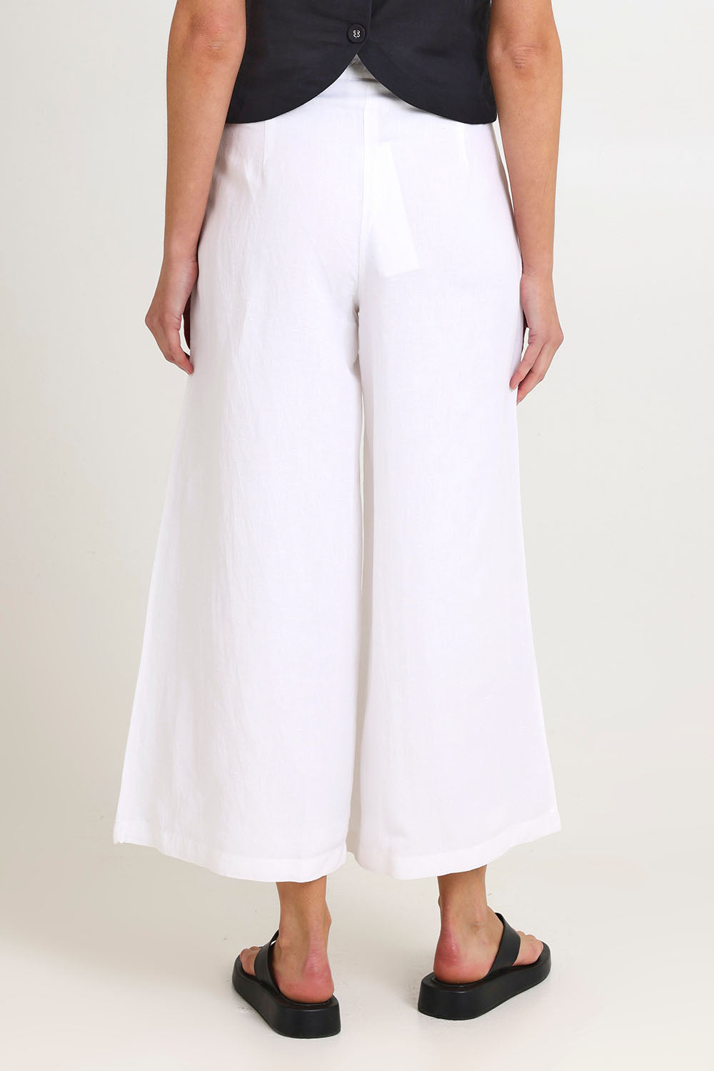Model Madeline wearing size 10 of the Jedda Linen Cotton Pant in colour White (White), from the back