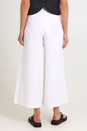 Model Madeline wearing size 10 of the Jedda Linen Cotton Pant in colour White (White), from the back