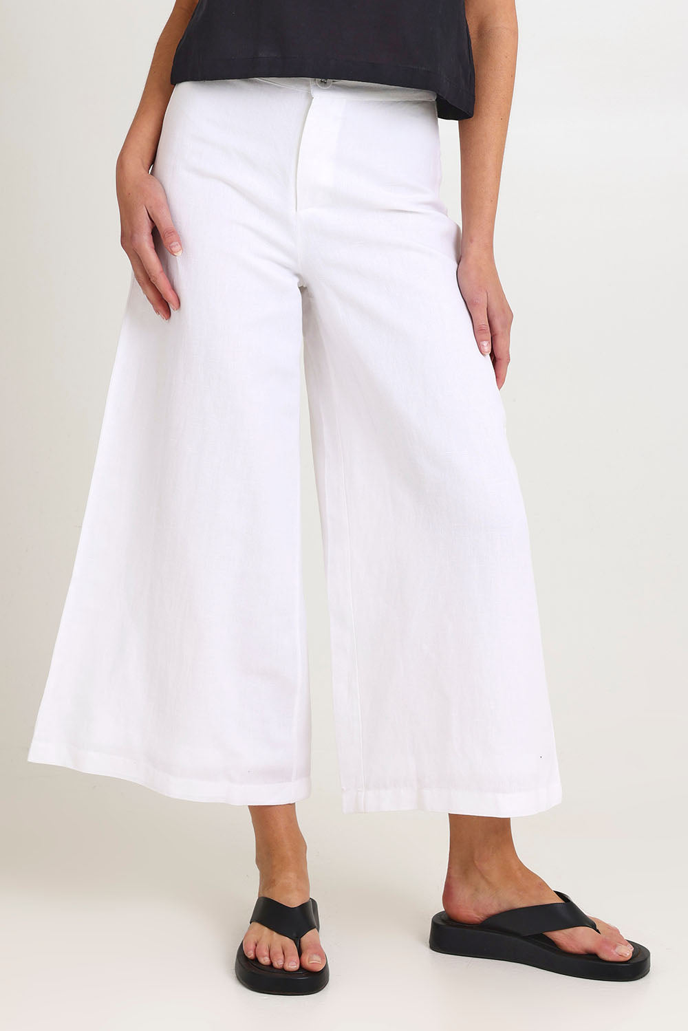 Model Madeline wearing size 10 of the Jedda Linen Cotton Pant in colour White (White), from the front, cropped image