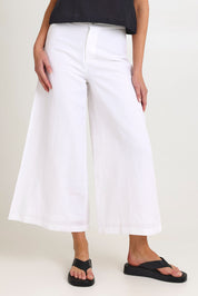 Model Madeline wearing size 10 of the Jedda Linen Cotton Pant in colour White (White), from the front, cropped image