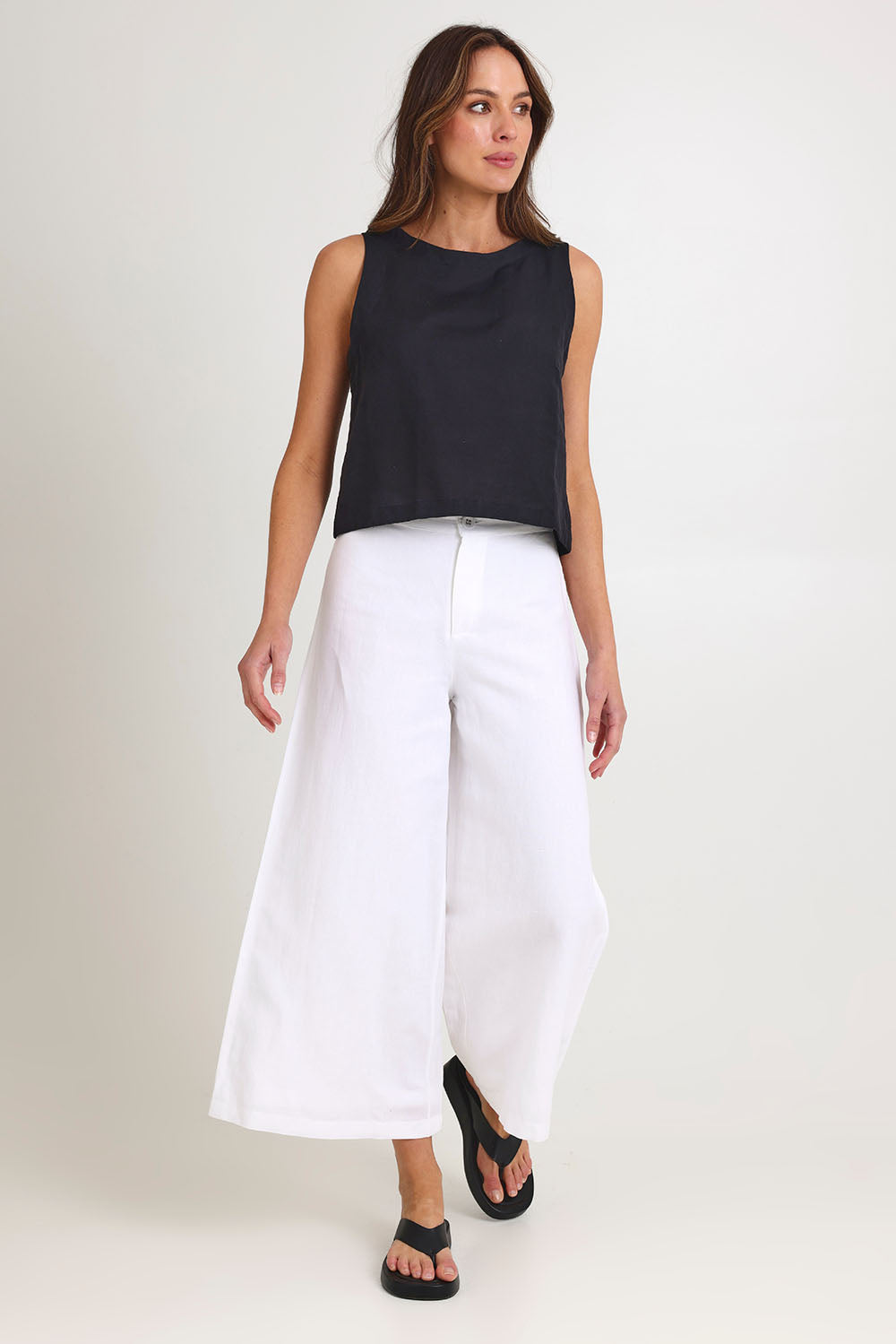 Model Madeline wearing size 10 of the Jedda Linen Cotton Pant in colour White (White), from the front, showing the whole outfit