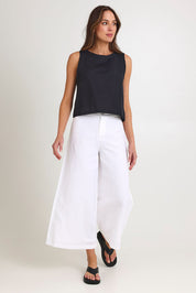 Model Madeline wearing size 10 of the Jedda Linen Cotton Pant in colour White (White), from the front, showing the whole outfit