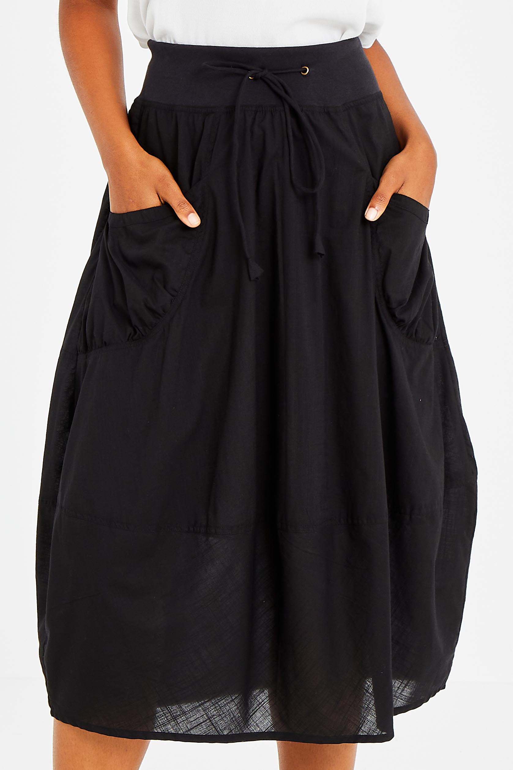 Model Olivia wearing size 10 of the Guru Skirt in colour Black (Black), from the front, cropped image