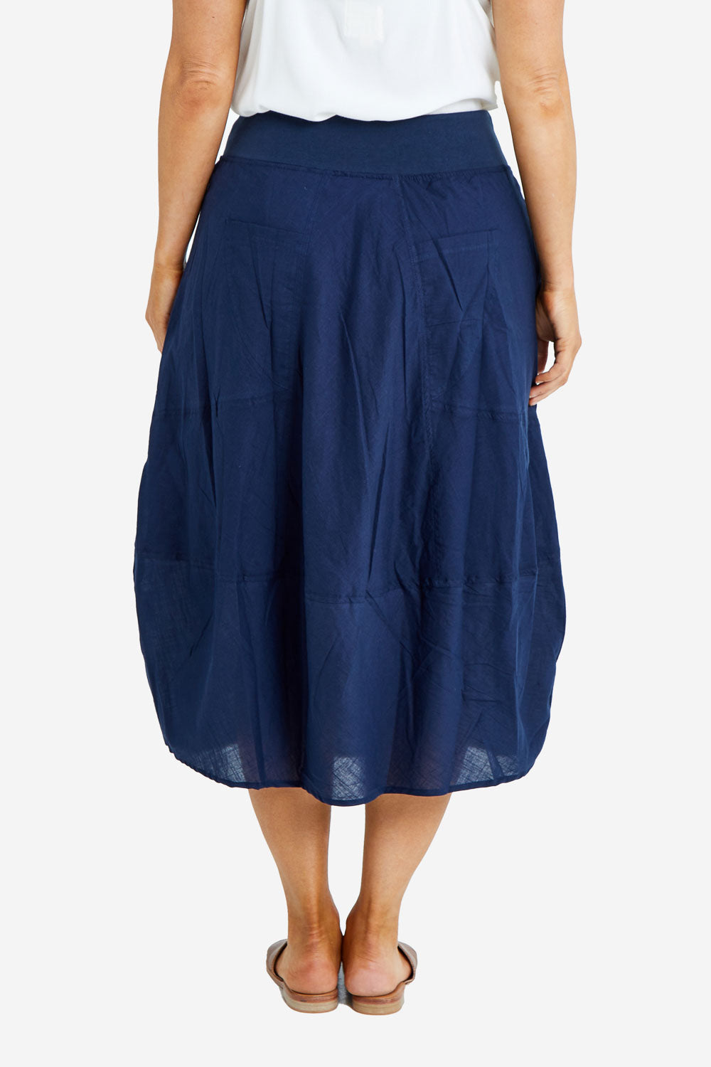 Model Laura wearing size 14 of the Guru Skirt in colour Navy (Blue), from the back