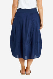 Model Laura wearing size 14 of the Guru Skirt in colour Navy (Blue), from the back