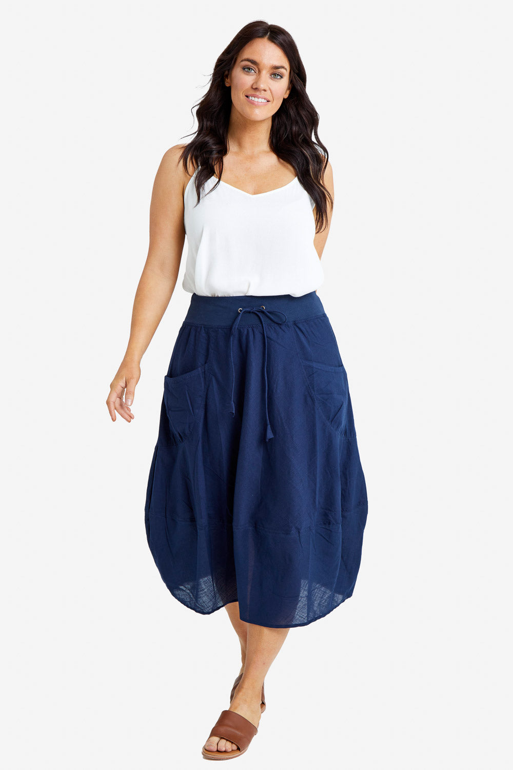 Model Laura wearing size 14 of the Guru Skirt in colour Navy (Blue), from the front, showing the whole outfit