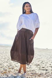 Model Eshan wearing size 10 of the Guru Cotton Skirt - Coffee in colour Coffee, from the front