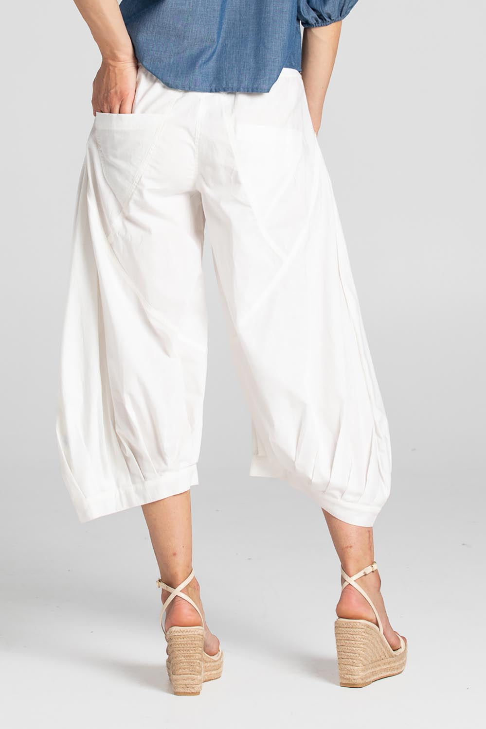 A model wearing the Guru Pant in colour White (White), from the back