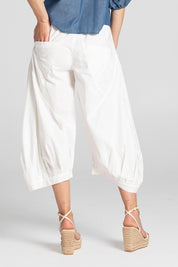 A model wearing the Guru Pant in colour White (White), from the back