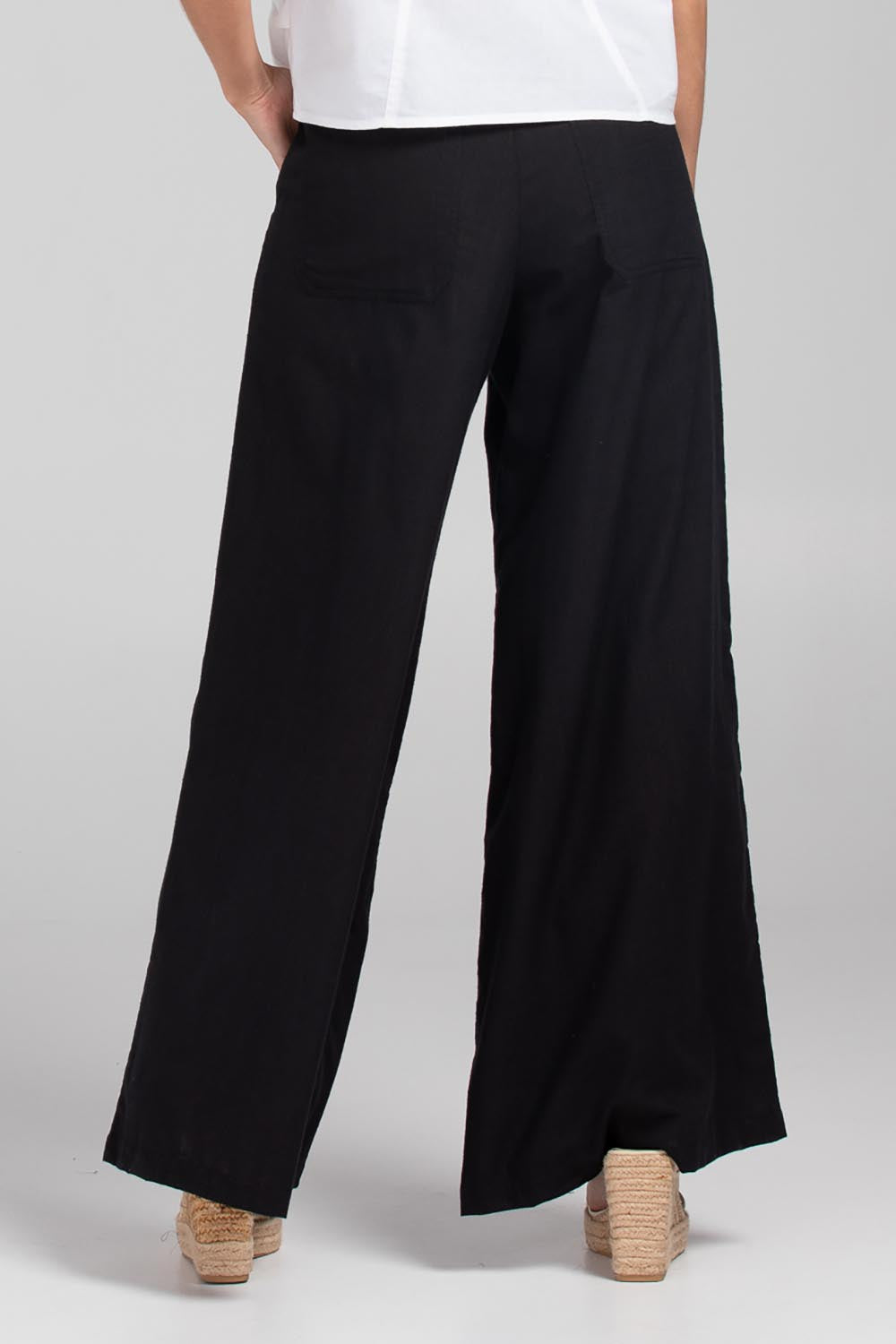 A model wearing the Luca Cotton Pant in colour Black (Black), from the back