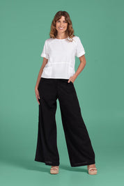 A model wearing the Luca Cotton Pant in colour Black (Black), from the front, showing the whole outfit