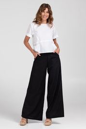 A model wearing the Luca Cotton Pant in colour Black (Black), from the front, showing the whole outfit