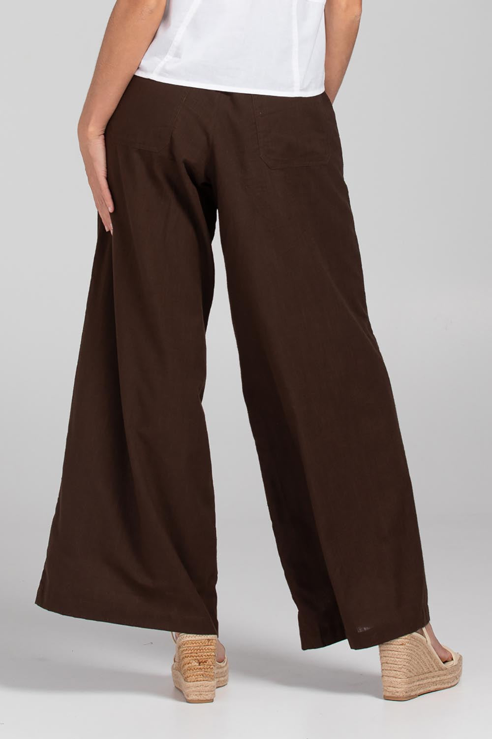 A model wearing the Luca Cotton Pant in colour Coffee, from the back