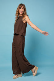 A model wearing the Luca Cotton Pant in colour Coffee, from the front, showing the whole outfit