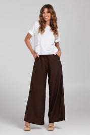 A model wearing the Luca Cotton Pant in colour Coffee, from the front, showing the whole outfit